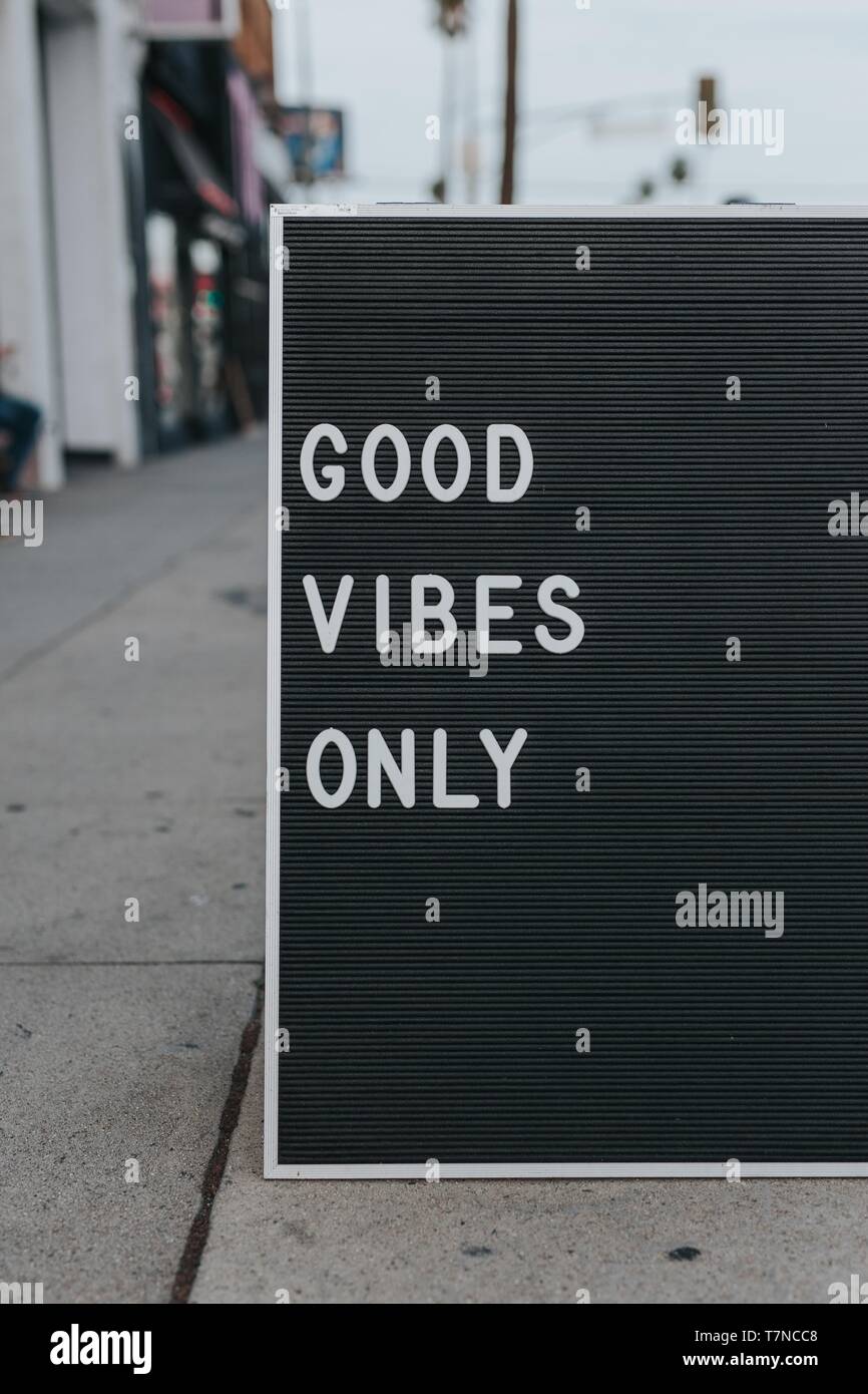 Sunset Strip sidewalk sign saying: "GOOD VIBES ONLY" on a black/grey board Stock Photo