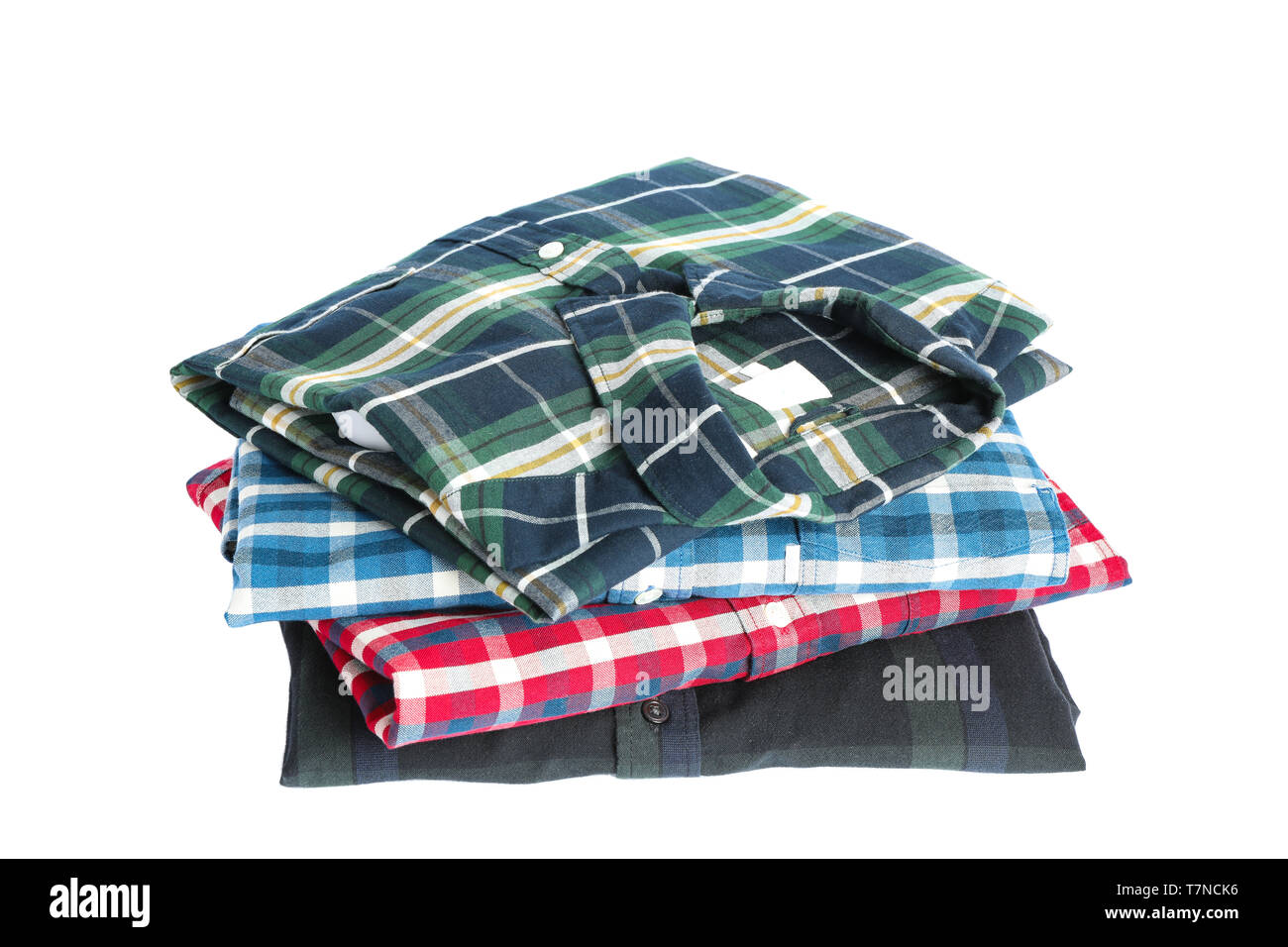 Stack of colorful shirts isolated on white background Stock Photo