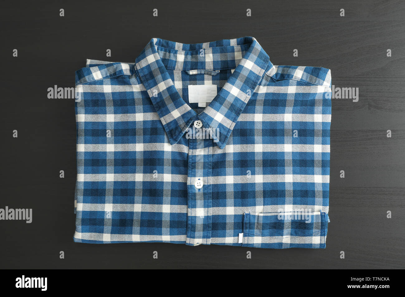 Folded checkered shirt on black table, top view Stock Photo