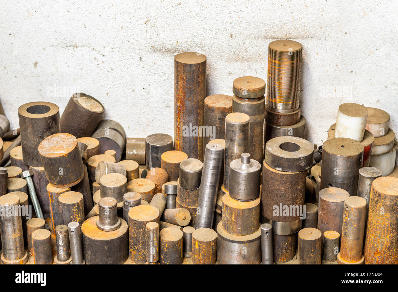 Lathed steel bar stack on factory floor Stock Photo