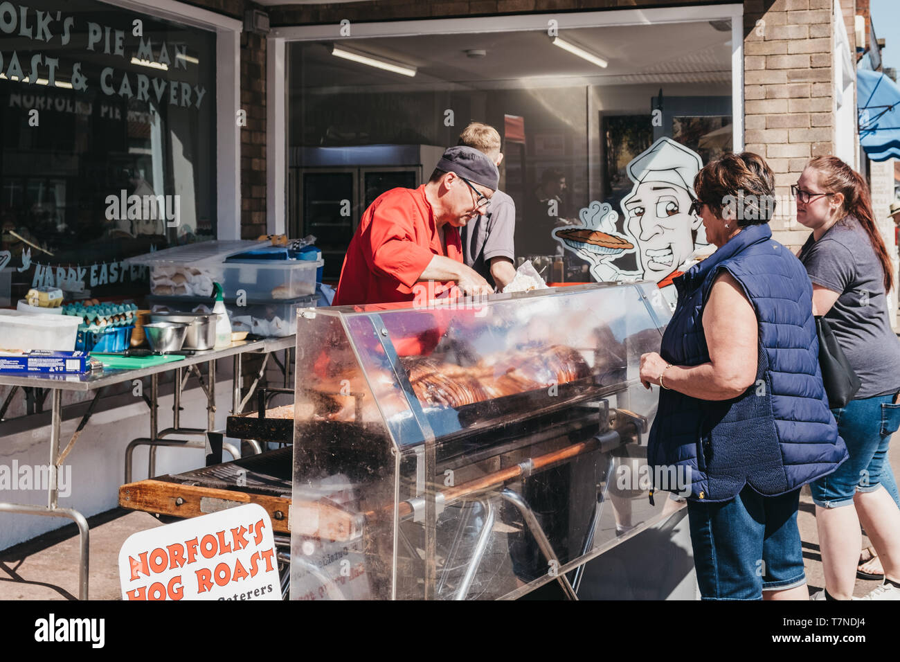 Sheringham, UK April 21, 2019 Woman buying hog roast from a street food market stall in