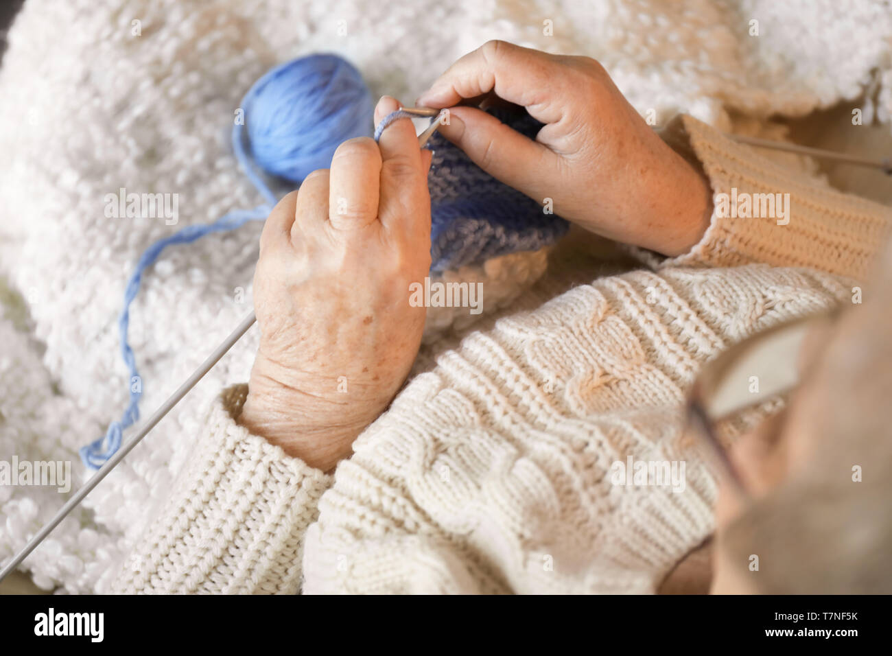 Senior woman knitting warm sock, closeup Stock Photo