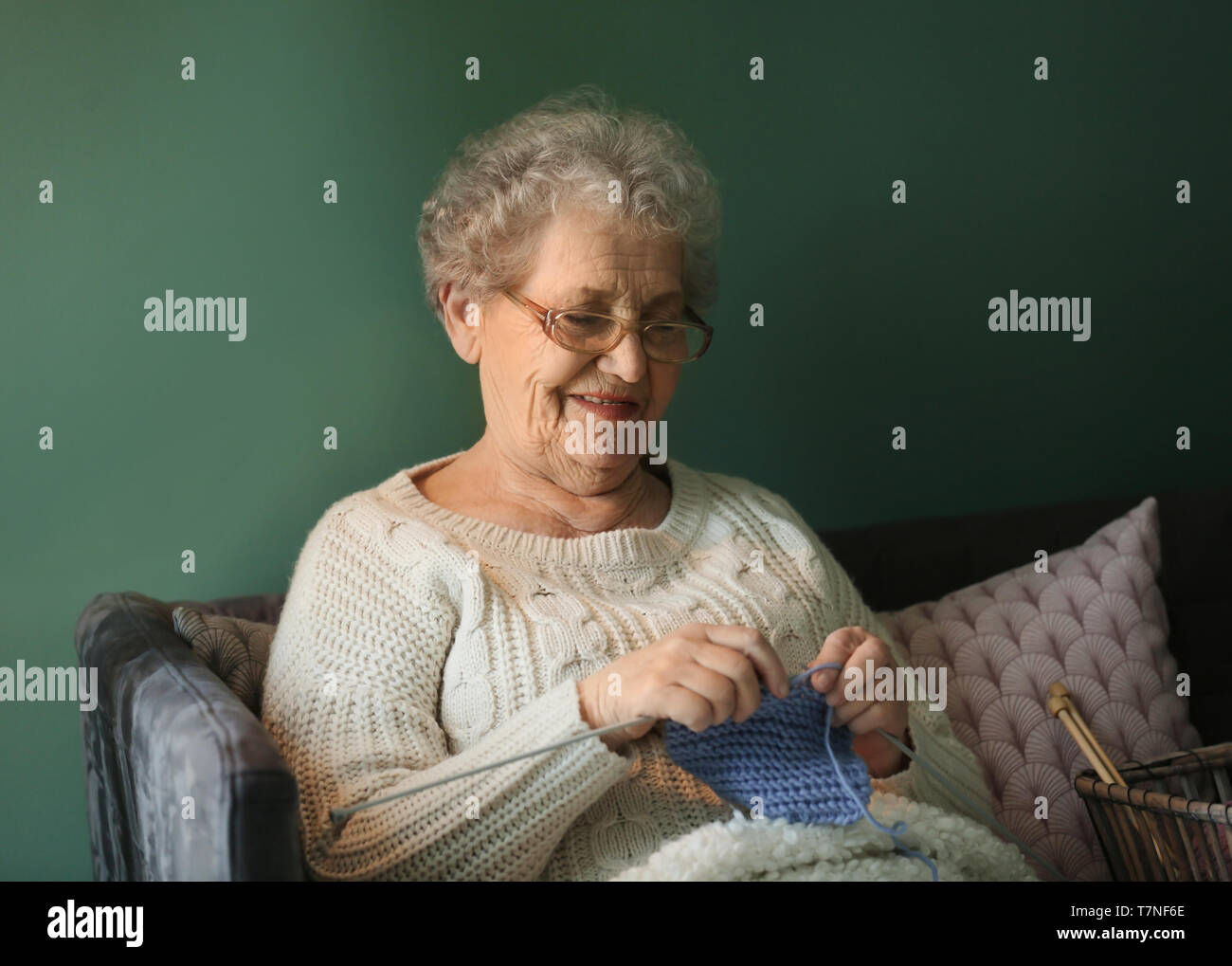 Senior woman knitting warm sock at home Stock Photo
