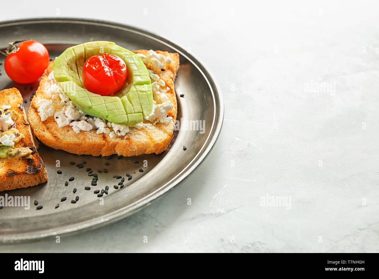 Plate with tasty toast on light background Stock Photo - Alamy