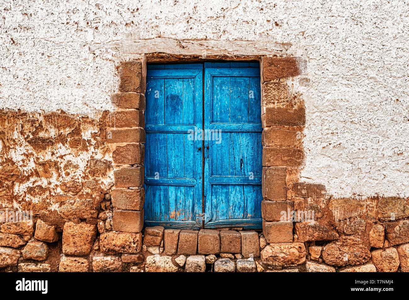 Rustic doors to the house on the street of Chinchero, a small town of Urubamba Province in Peru. Stock Photo