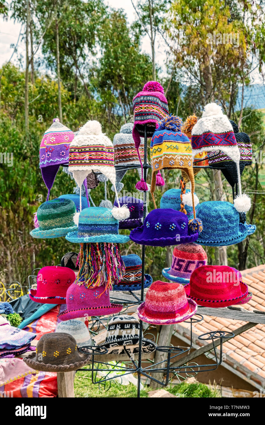 Locally knitted hats made of Alpaca wool for sale by the road near Chinchera the small town of Urubamba Province in Peru. Stock Photo