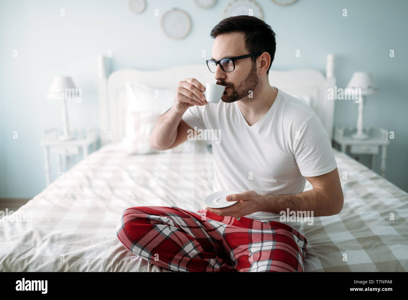 Portrait of handsome young man drinking coffee Stock Photo