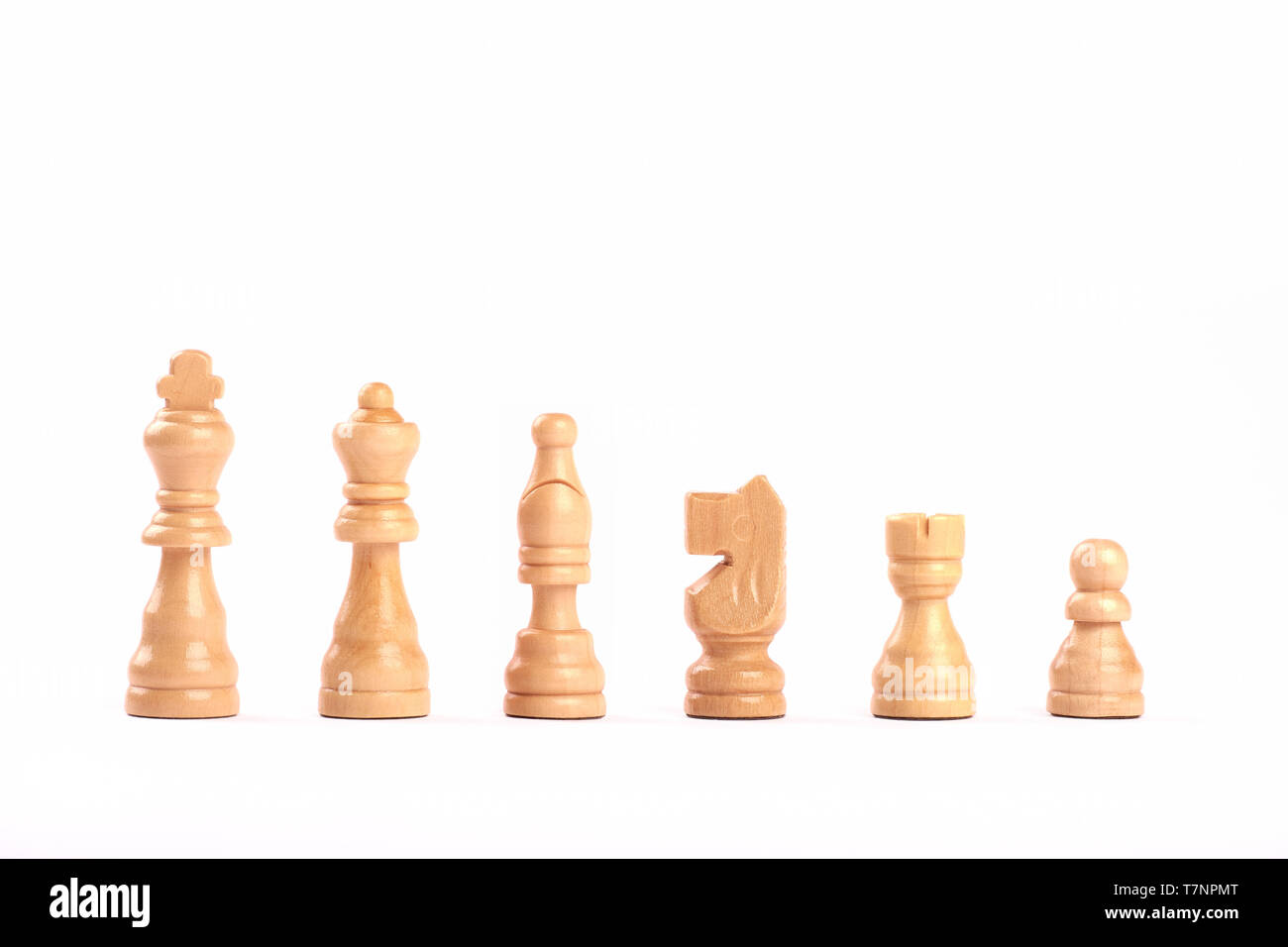 Set of white wooden chess figures standing in a row isolated on white background Stock Photo