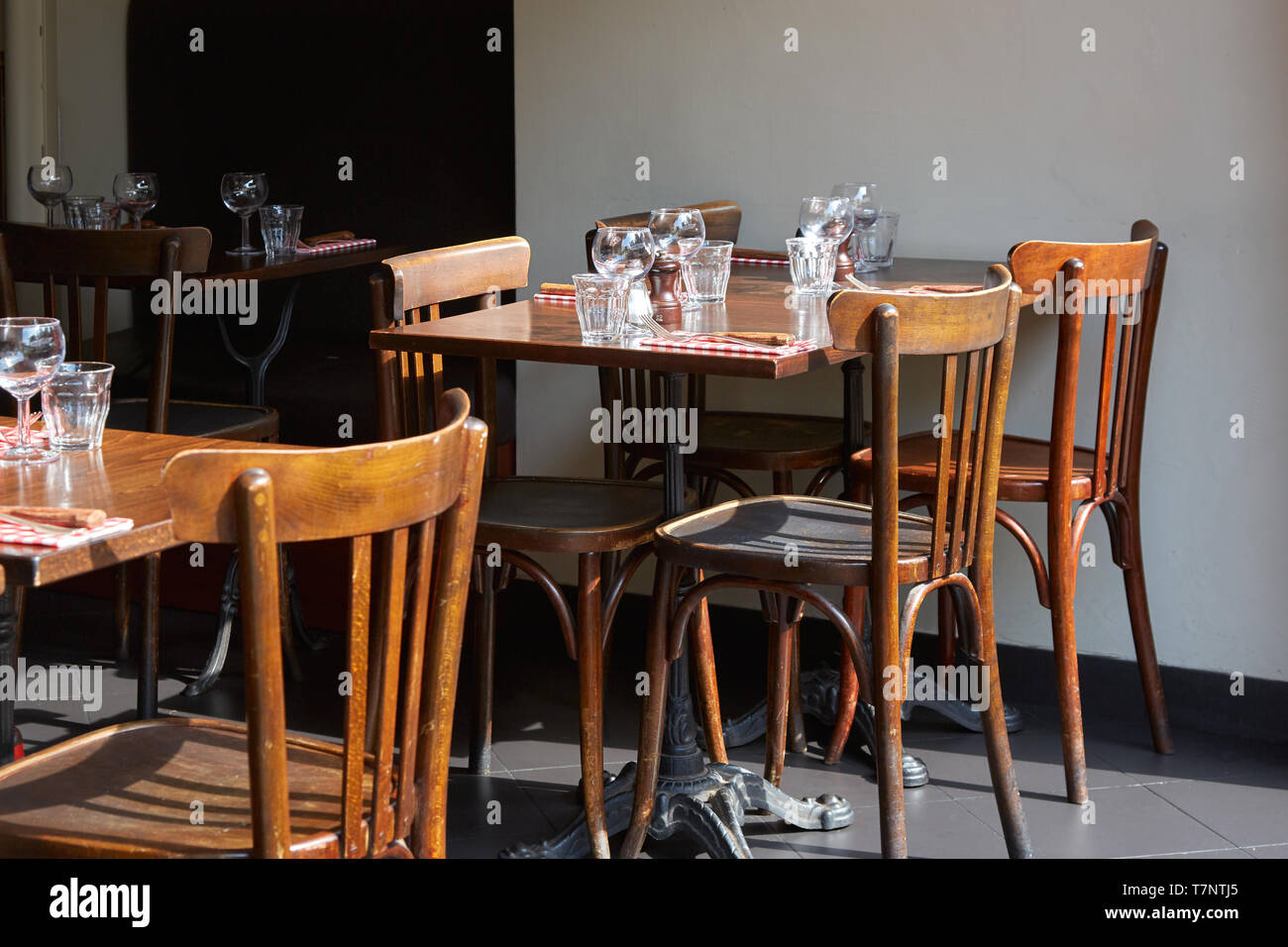 Brown wooden restaurant tables and chairs in sunny summer day Stock Photo