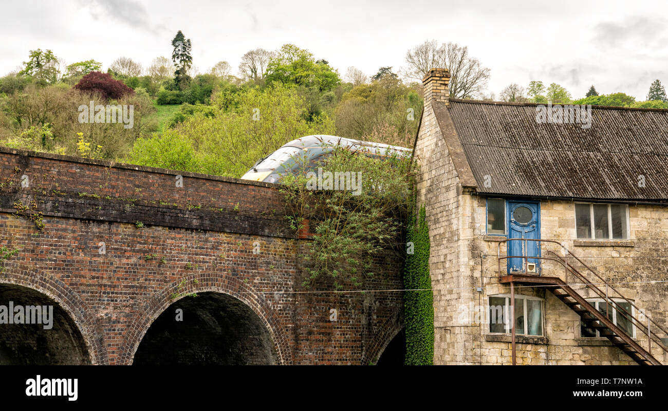 Old 18th Century mill buildings and modern Inter-City train, Brimscombe Port, Stroud, The Cotswolds, United Kingdom Stock Photo