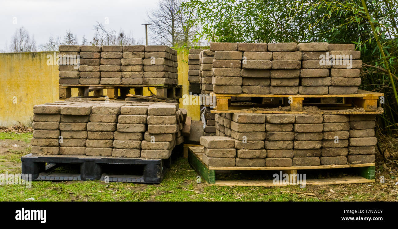 stacked pallets with construction materials, paving stones on a pallet