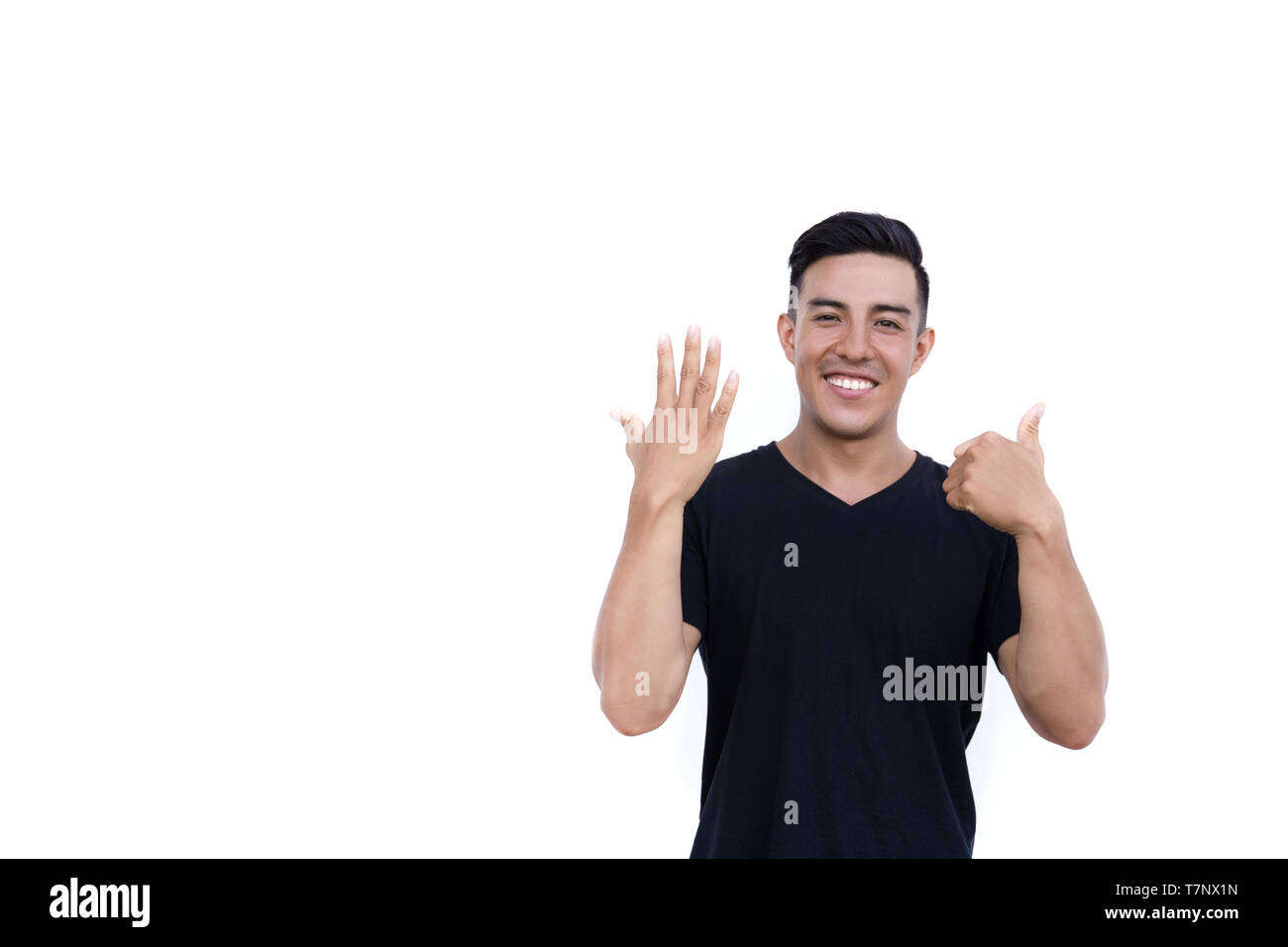 Handsome latin hispanic man is showing six fingers isolated on white background. Place for text and design. Stock Photo