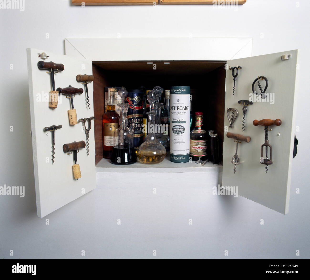 Vntage corkscrews on doors of alcove drinks cupboard Stock Photo