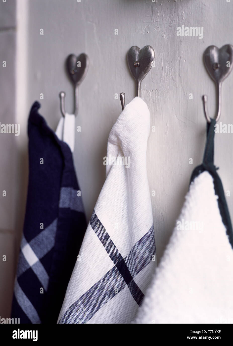 Heart shaped metal hooks with tea towels Stock Photo Alamy