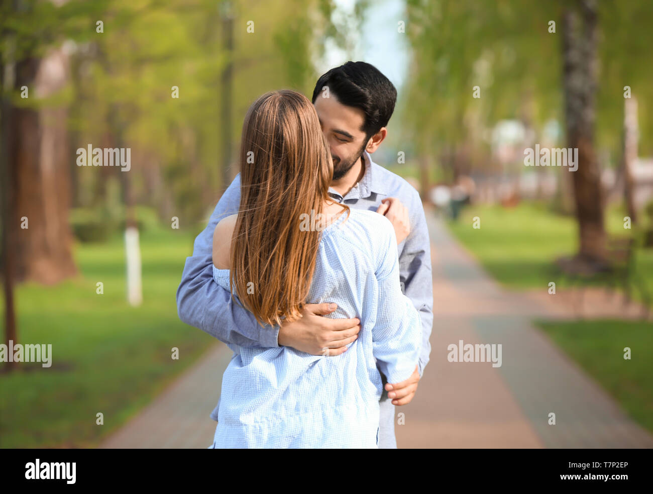 Lovely couple kissing in park hi-res stock photography and images - Alamy