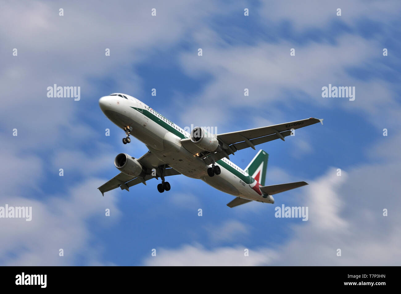 Alitalia Airbus A320 narrow body two-engine jet airplane approaches airport for landing Stock Photo