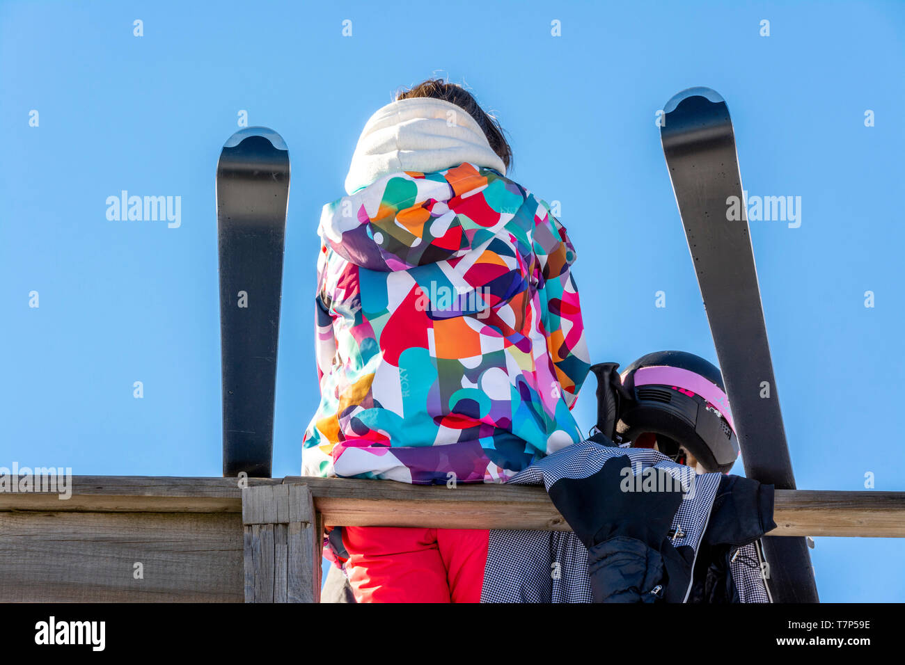 Young skier with a multicolored down jacket Stock Photo