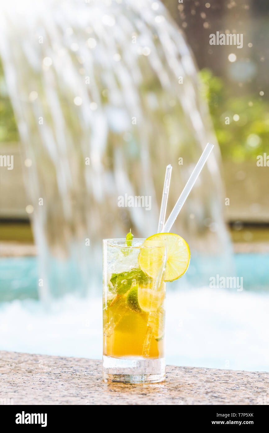 Glass of classic mojito cocktail with caipirinha on stone edge of ...