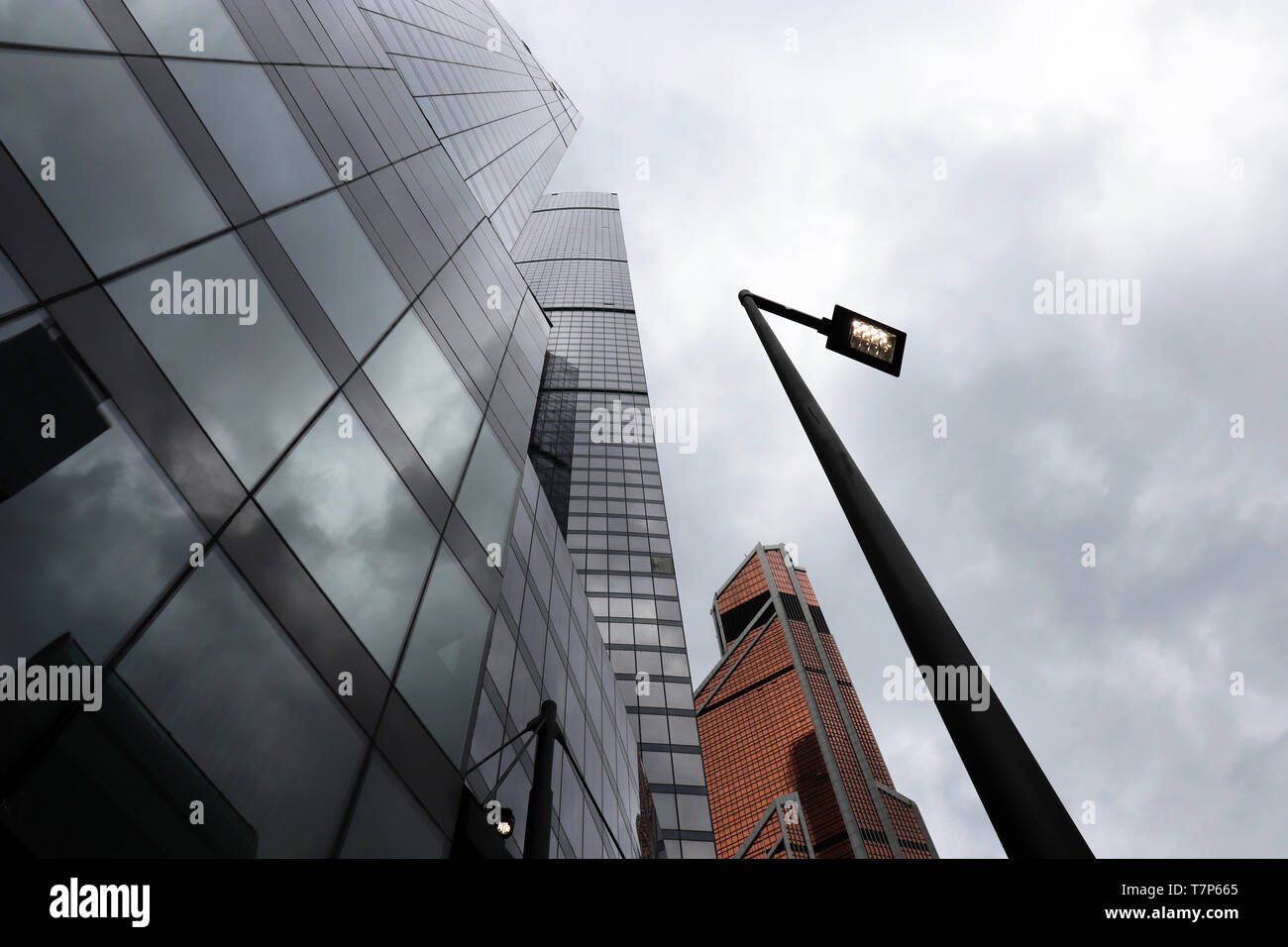 Skyscrapers of Moscow city on stormy cloudy sky background, bottom view. Futuristic city with dramatic sky, modern architecture, urbanization concept Stock Photo