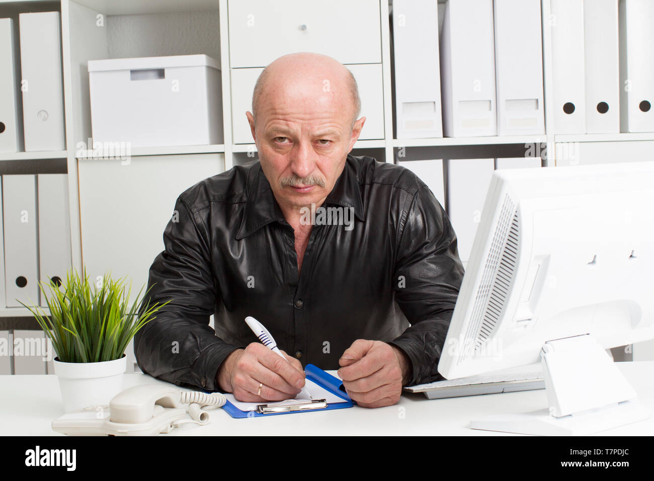 An elderly bald man at the computer. Pensioner in the workplace Stock ...