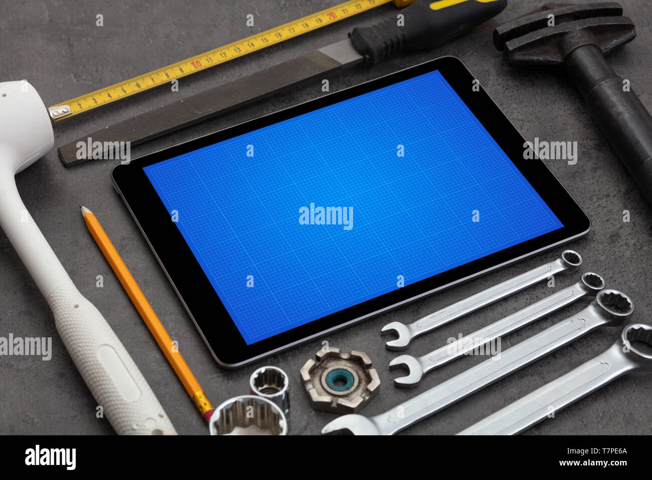 Household tools and tablet with grid screen concept Stock Photo