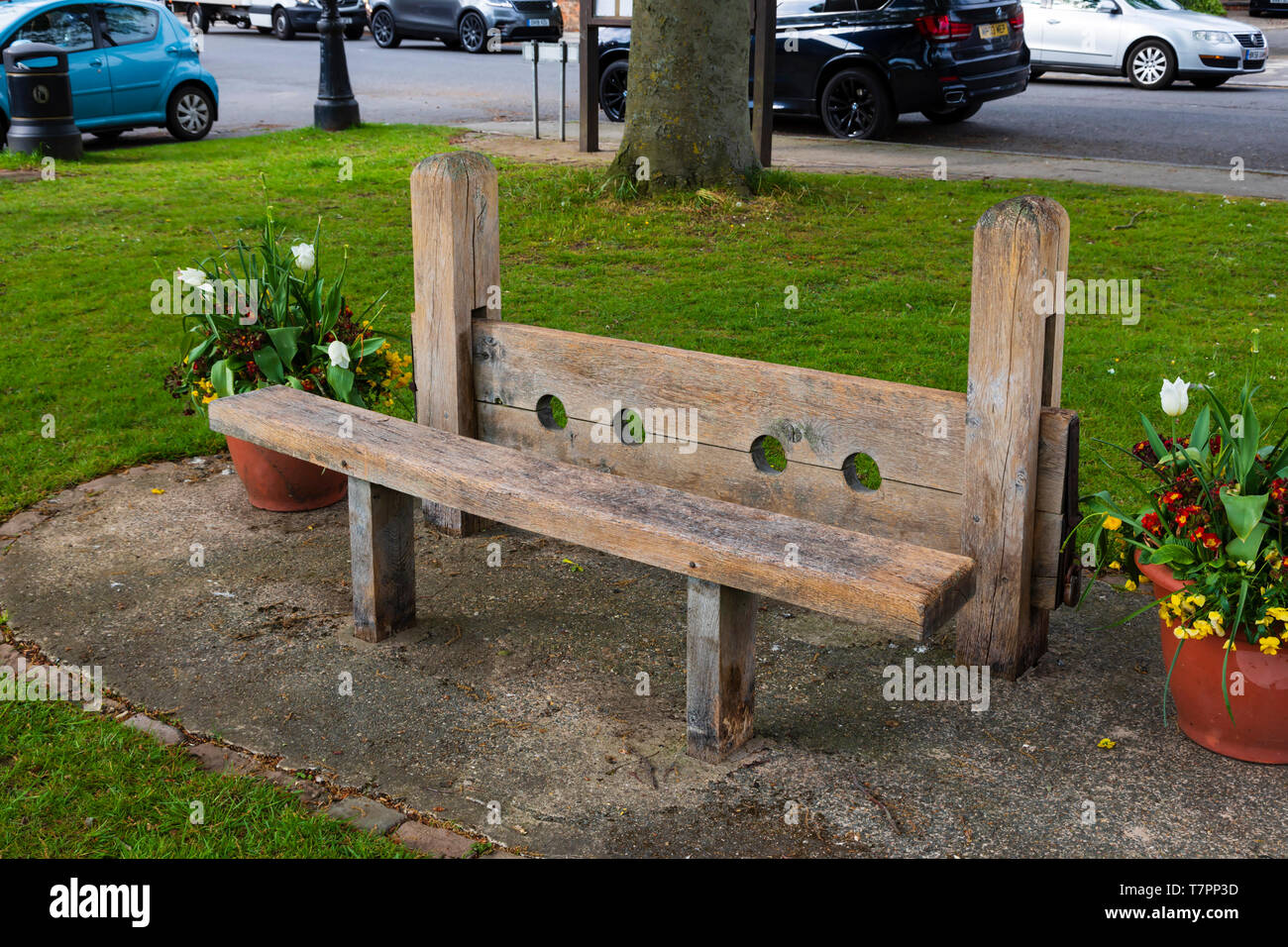 Medieval stocks on the village green, The village of Dunchurch, near Rugby, Warwickshire, West Midlands, England Stock Photo