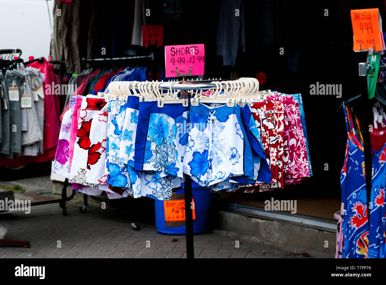 Beach shorts for sale on a stand in Perranporth, Cornwall. Stock Photo