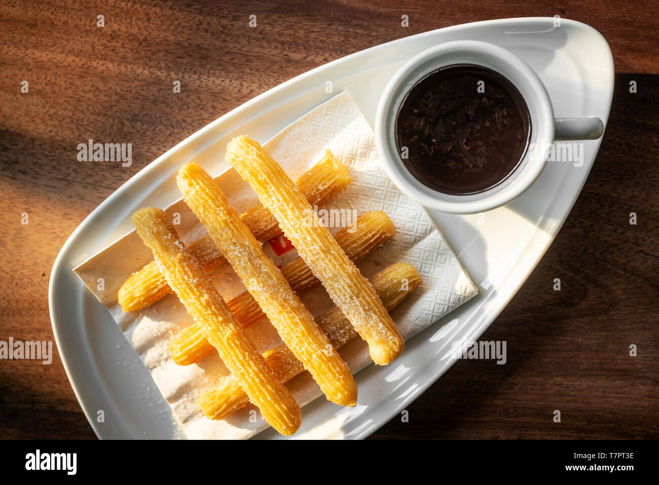 churros con chocolate traditional spanish sweet breakfast set on wooden table Stock Photo