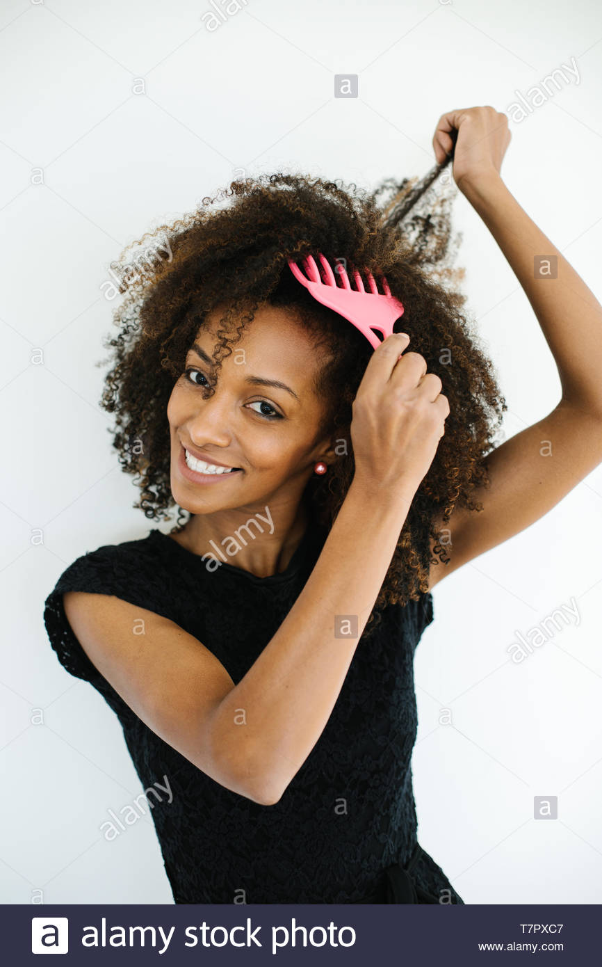 Pretty Afro Hairstyle Woman Using Comb For Untangle Her Curly Hair