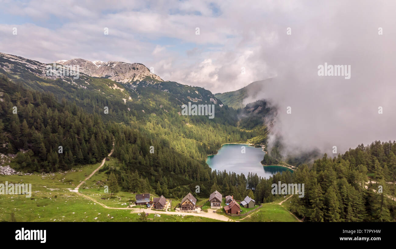 Scenic mountain landscape with rugged peaks, forests, lake and the village of Tauplitzalm, Bad Mitterndorf in the Austria alps Stock Photo