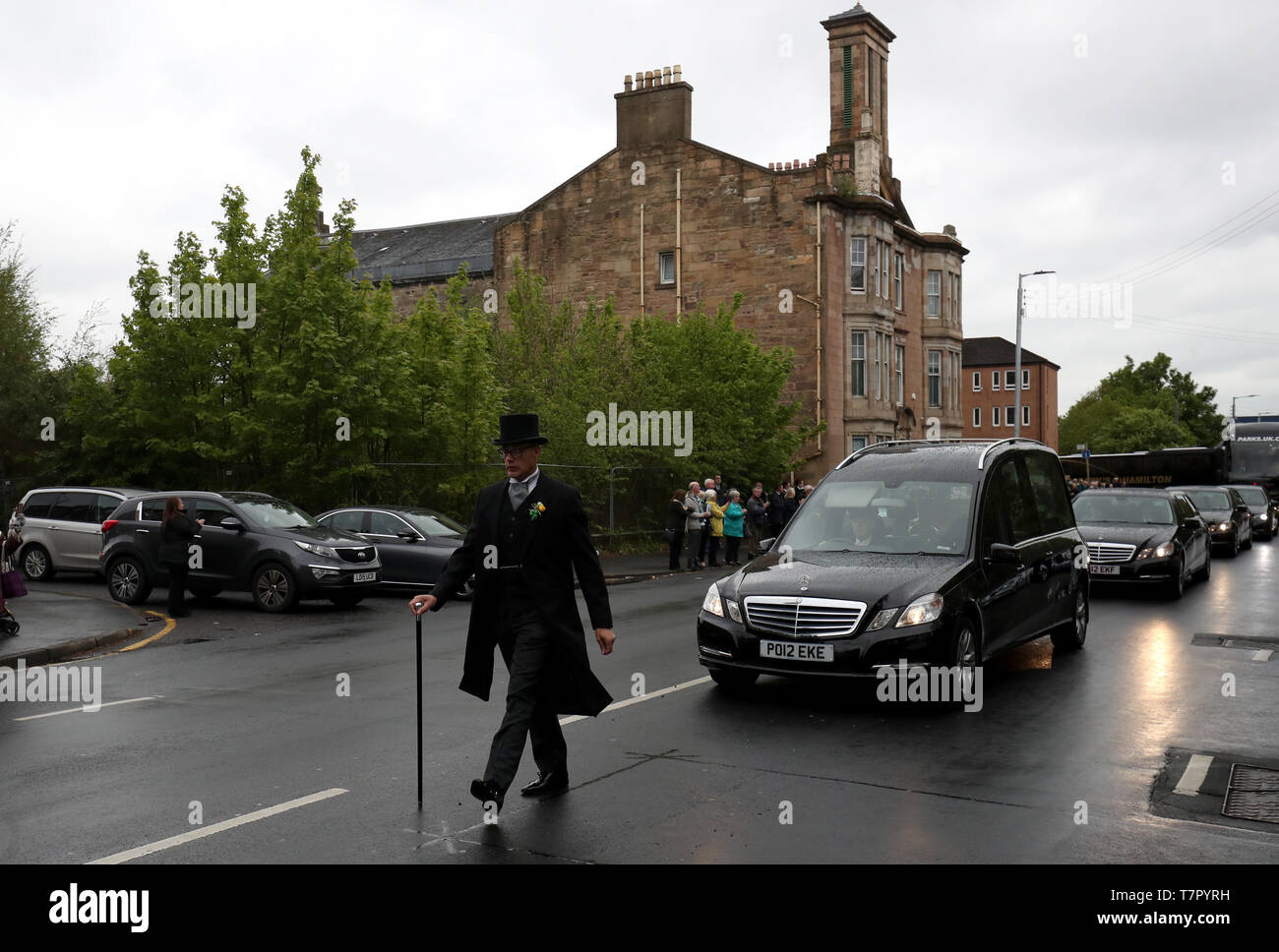 The funeral procession passes through the Calton are of Glasgow. Stock Photo