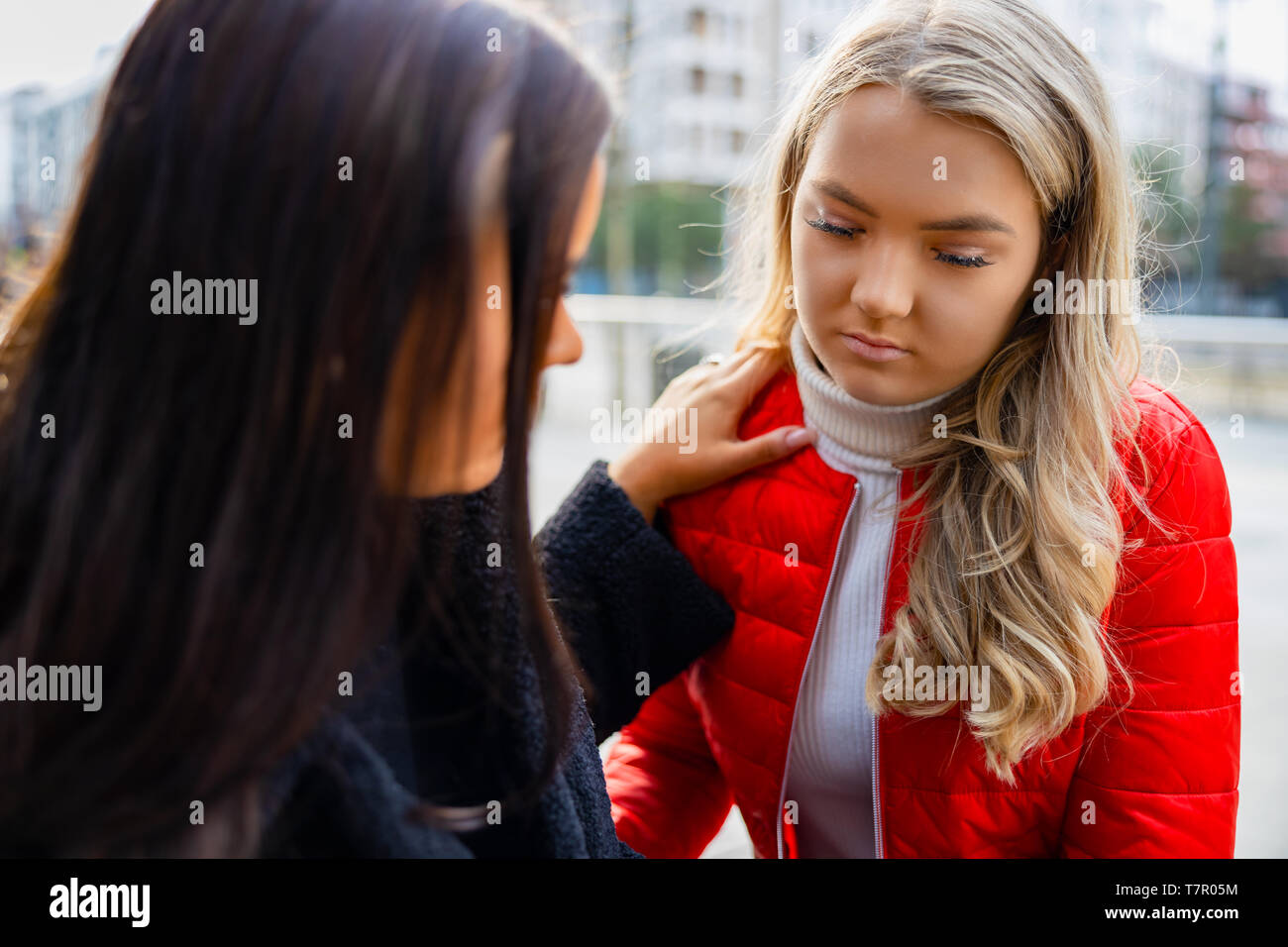 Young Woman Comforting Her Upset and Sad Friend Outdoor Stock Photo
