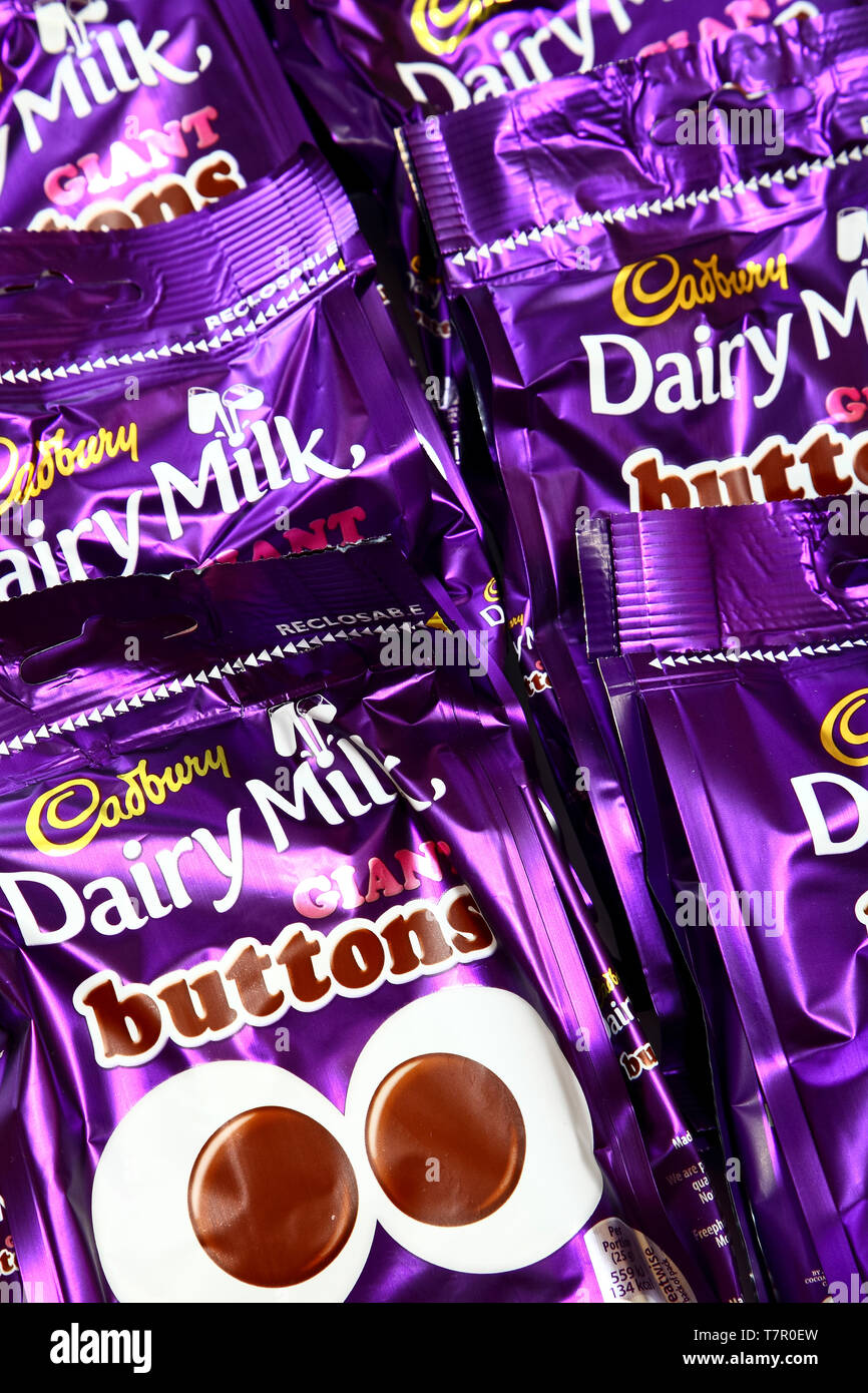 Packets of cadbury dairy milk giant buttons Stock Photo Alamy