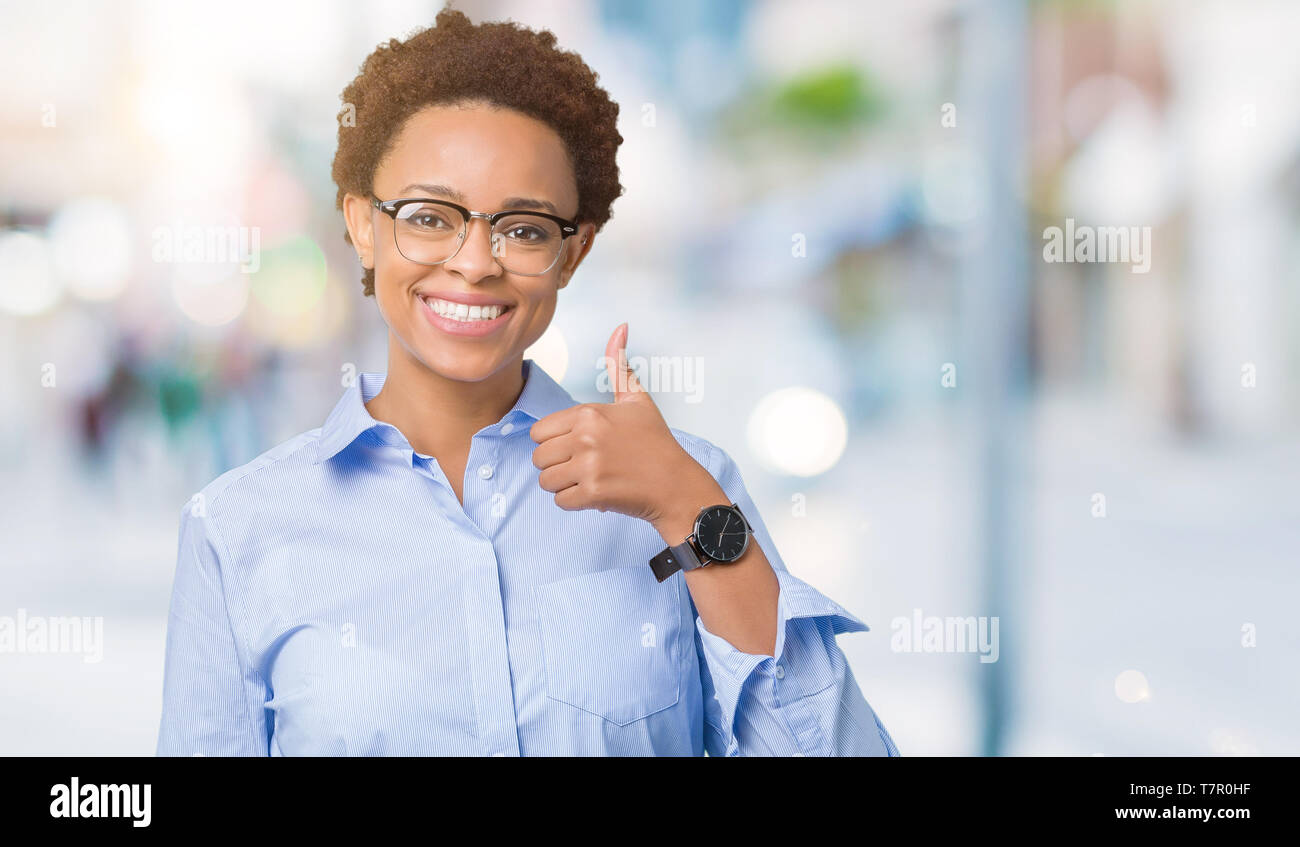 Young beautiful african american business woman over isolated ...