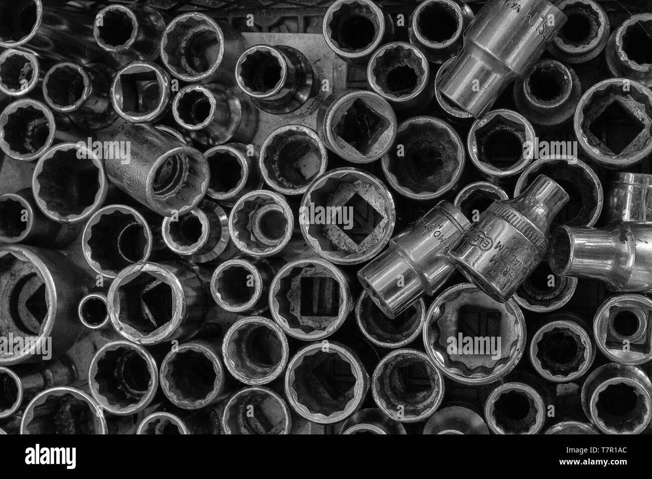 A close up of a black and white image of socket set heads, of various sizes. Stock Photo