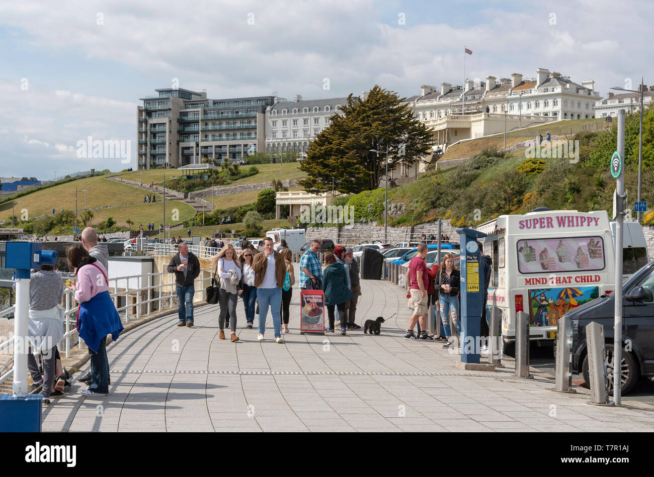 Plymouth, Devon, England, UK. May 2019. People walking on the waterfront with a view of property on The Hoe area of Plymouth UK. Stock Photo