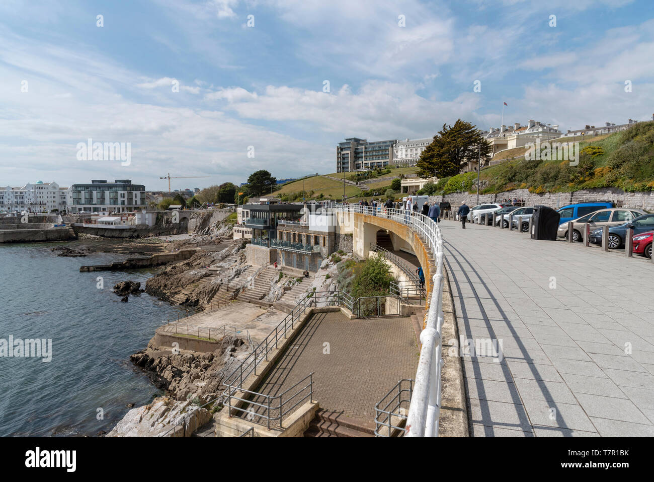 Plymouth, Devon, England, UK. May 2019. People walking on the waterfront with a view of property on The Hoe area of Plymouth and the lower Colonnade Stock Photo