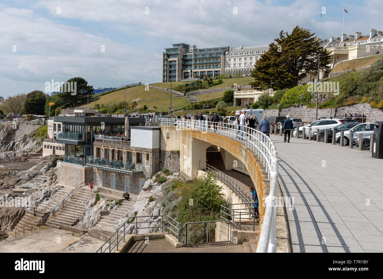 Plymouth, Devon, England, UK. May 2019. People walking on the waterfront with a view of property on The Hoe area of Plymouth and the lower Colonnade Stock Photo