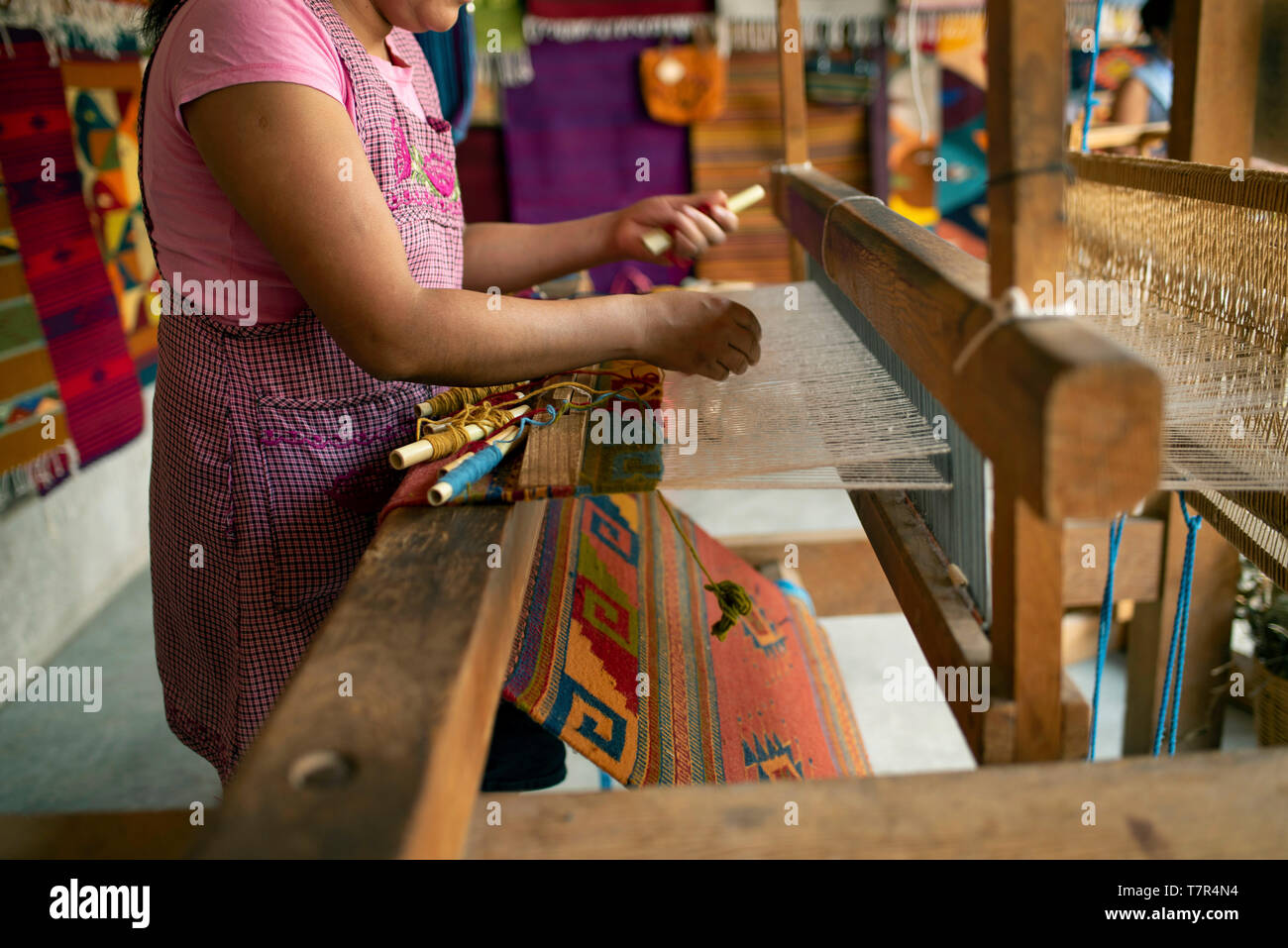 Woman weaving a rug on a pedal loom. Teotitlan del Valle, Oaxaca