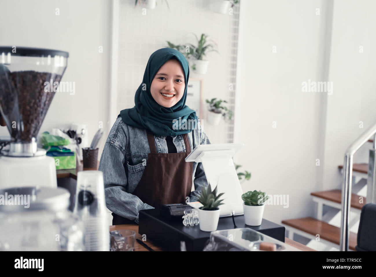 muslim waiter in cafe counter Stock Photo
