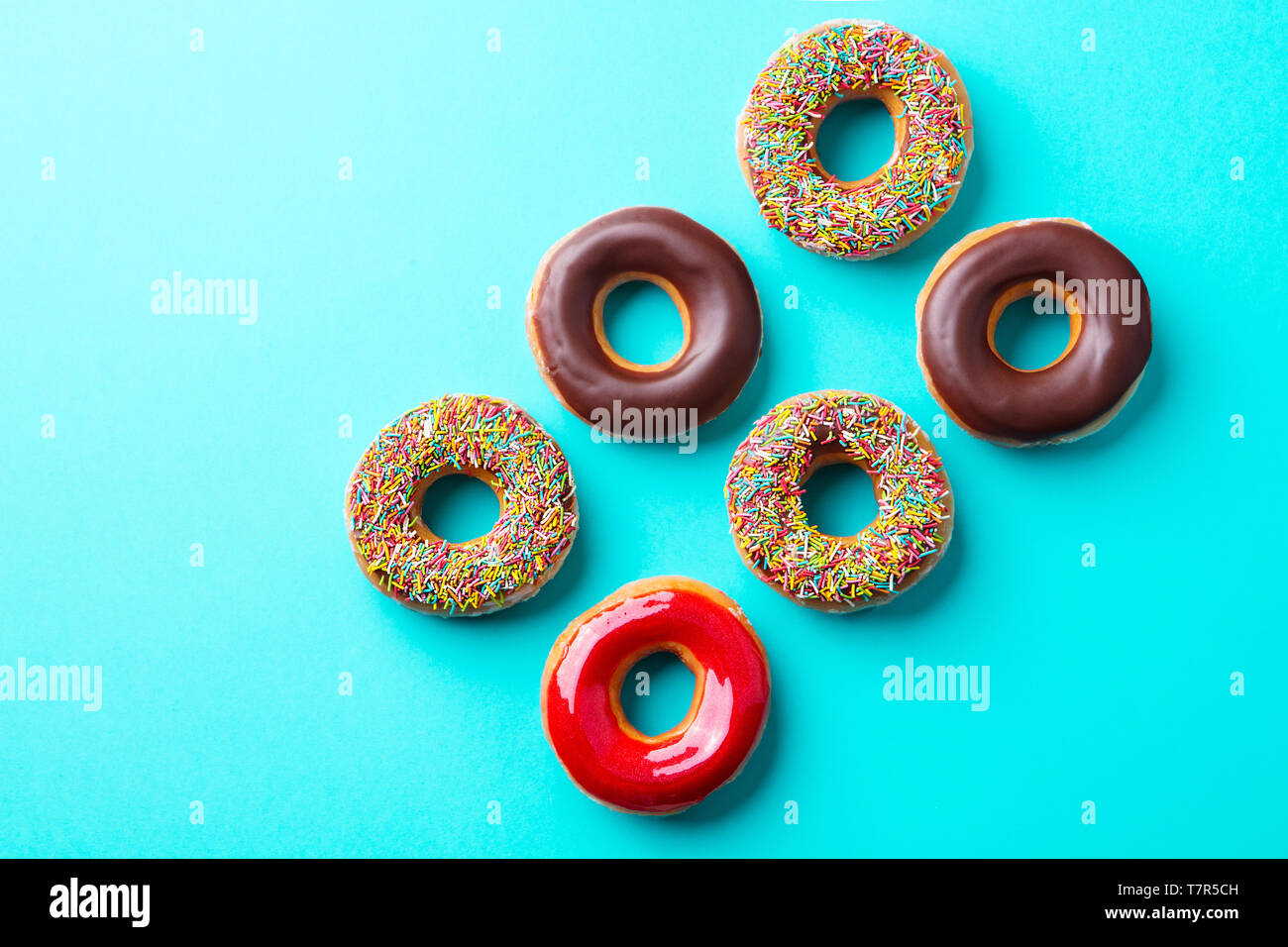 Assortment of donuts on blue background. Copy space. Top view Stock ...