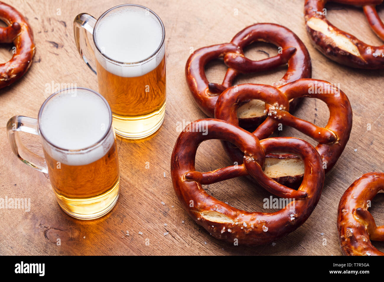 Beer and salted pretzels on wooden table background. Close up. Stock Photo