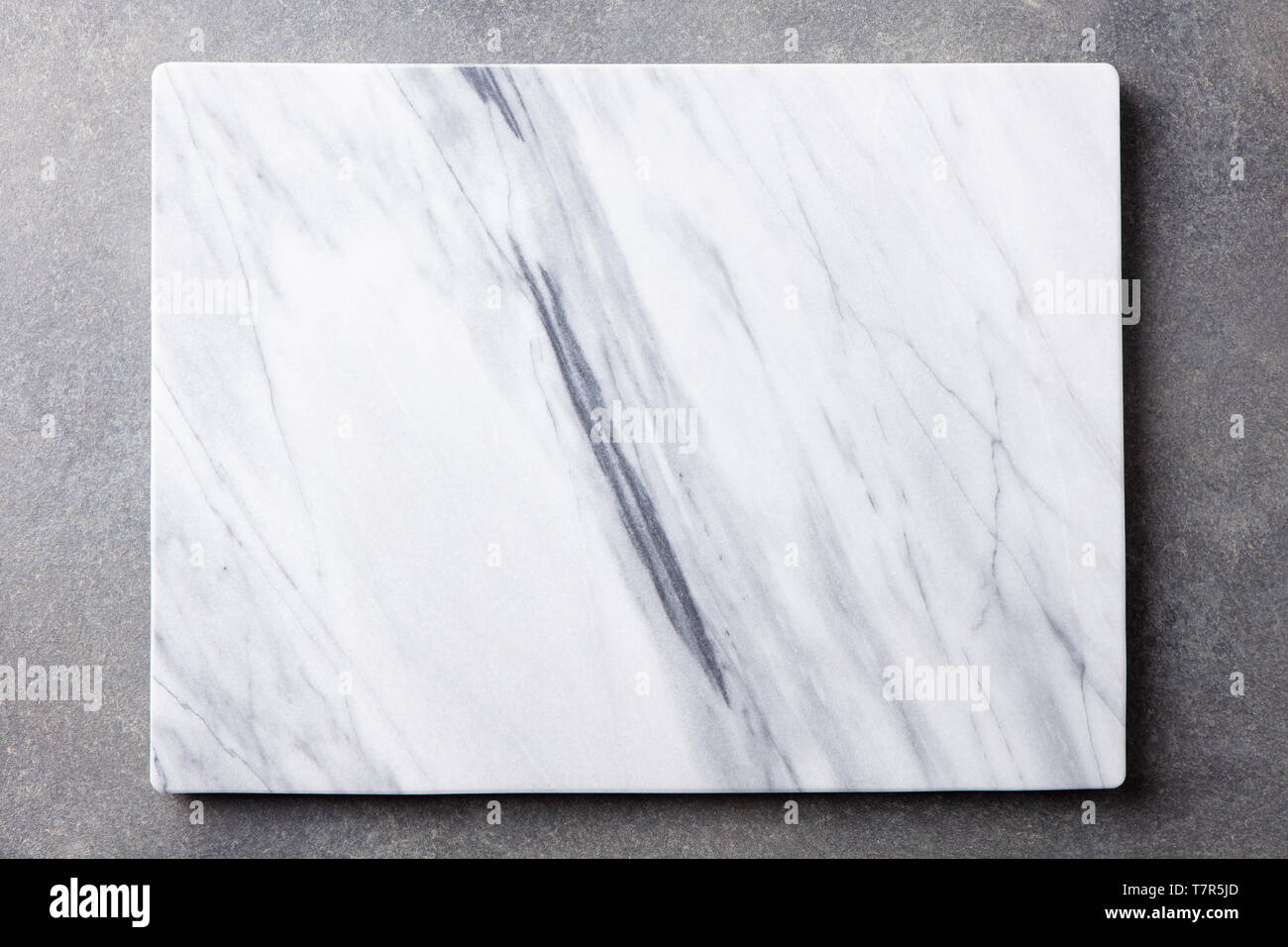 White marble texture board on grey background. Top view. Copy space. Stock Photo