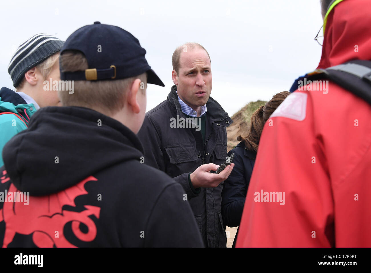The Duke of Cambridge holds a shell as he explores the wildlife habitat ...