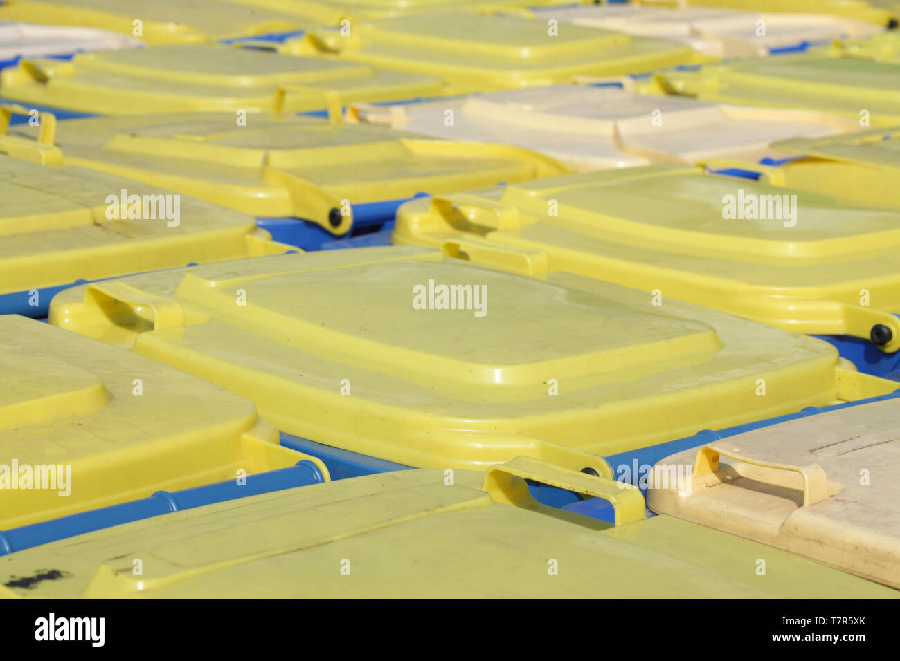 Yellow and blue tons, recycling bins, lids Stock Photo Alamy