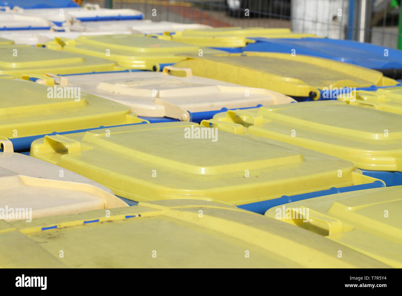Yellow and blue tons, recycling bins, lids Stock Photo Alamy