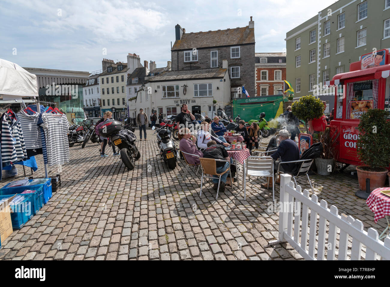 Plymouth, Devon, England, UK. May 2019.  Bikers seated with their machines close by on a Barbican cafe. A waterfront a meeting place for bike riders Stock Photo