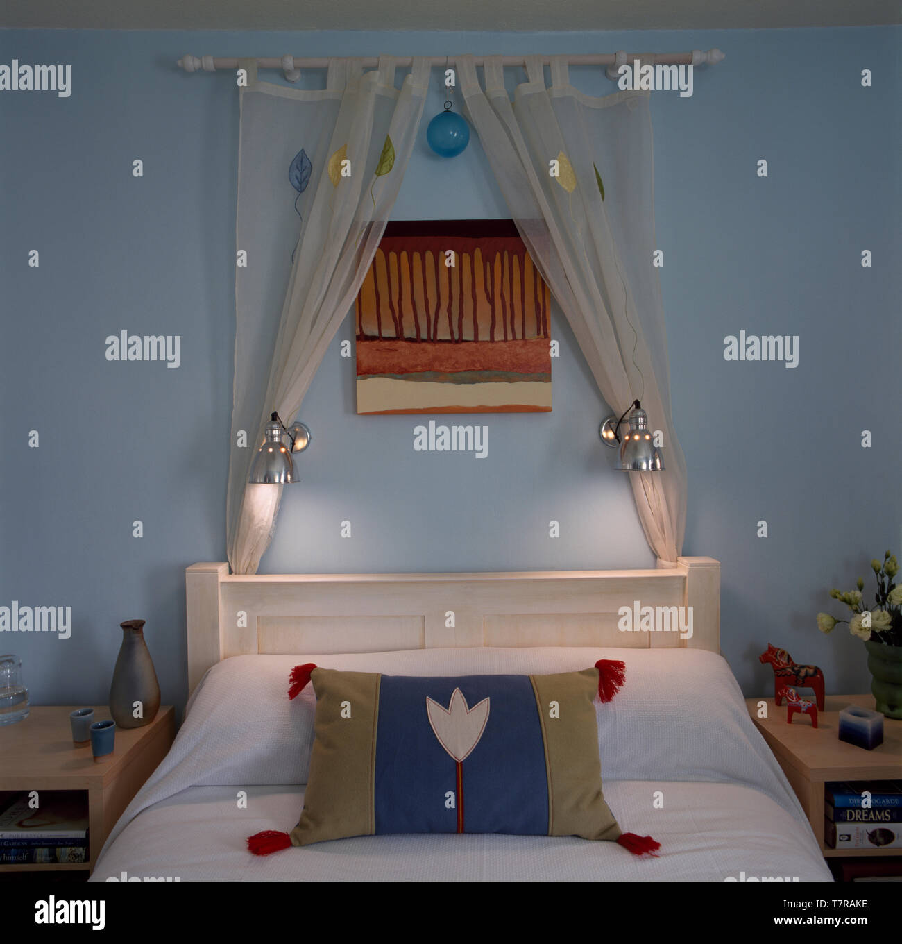 White Voile Drapes And Wall Lights Above Bed With Appliqued