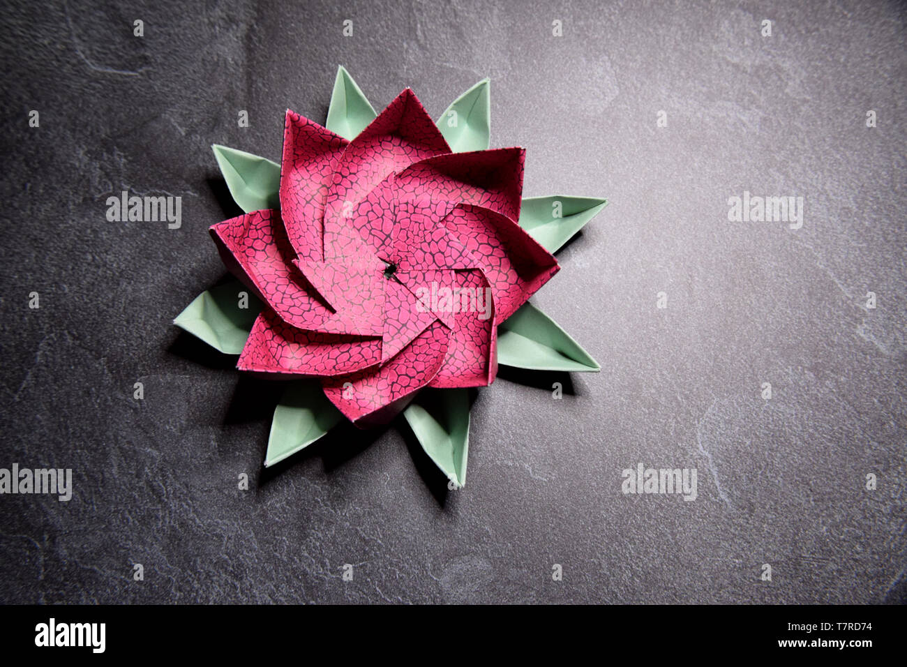 Pink Origami Lotus Flower - Ars and Crafts, Paper Art on Textured Stone  Backgrund Stock Photo - Alamy