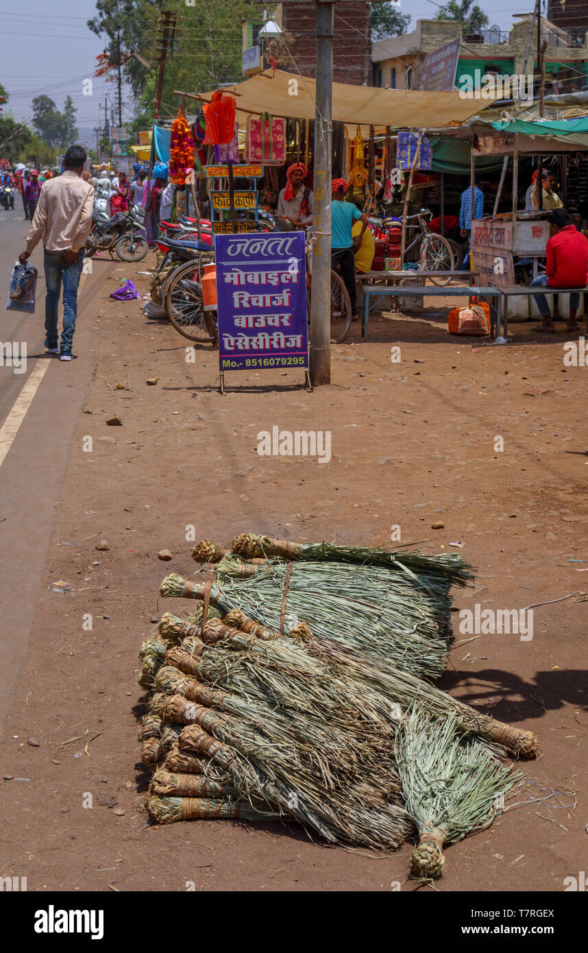 Broom heads on the side of the road for sale in the main street of Shahpura, a Dindori district town of the central Indian state of Madhya Pradesh Stock Photo